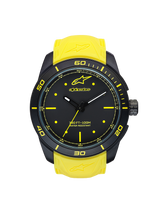 Alpinestars Tech Watch 3H, motorsport timepiece with black matte case and yellow silicone strap, water resistant 100M, front view showing analog dial with Alpinestars logo