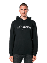 Alpinestars Blaze V3 Hoodie, black with white logo, casual streetwear, featuring front kangaroo pocket and drawstring hood, worn by a man, modern motorsport-inspired design