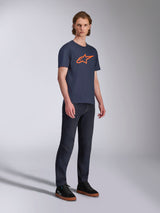 Alpinestars Ageless 2.0 CSF Tee, Short Sleeve T-Shirt, Navy Blue with Orange Star Logo, worn with dark denim jeans and black sneakers, casual motorsport-inspired streetwear