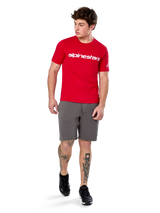 Alpinestars Linear Wordmark 2.0 CSF Tee, Short Sleeve T-Shirt, Red with white wordmark logo on chest, worn by model with grey shorts and black sneakers, casual motorsport-inspired streetwear