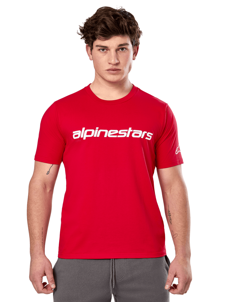 Alpinestars Linear Wordmark 2.0 CSF Tee, Short Sleeve T-Shirt, Red, White linear wordmark on chest and Ageless logo on sleeve, worn by male model with gray sweatpants, casual motorsport-inspired streetwear