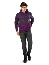 Alpinestars Perpetuate Hoodie, casual streetwear, purple heather fleece with dark purple fabric blocking on the kangaroo pocket and sleeves, black chest logo, drawstring hood, worn by model with dark grey jeans and black sneakers