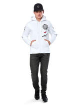 Alpinestars Variegate Hoodie, White Zip-Up Fleece Hoodie, multi-logo artwork with 'ASTARS' and red star logo on chest, graphic details on sleeves, worn by model with black cap and black jeans, casual motorsport streetwear