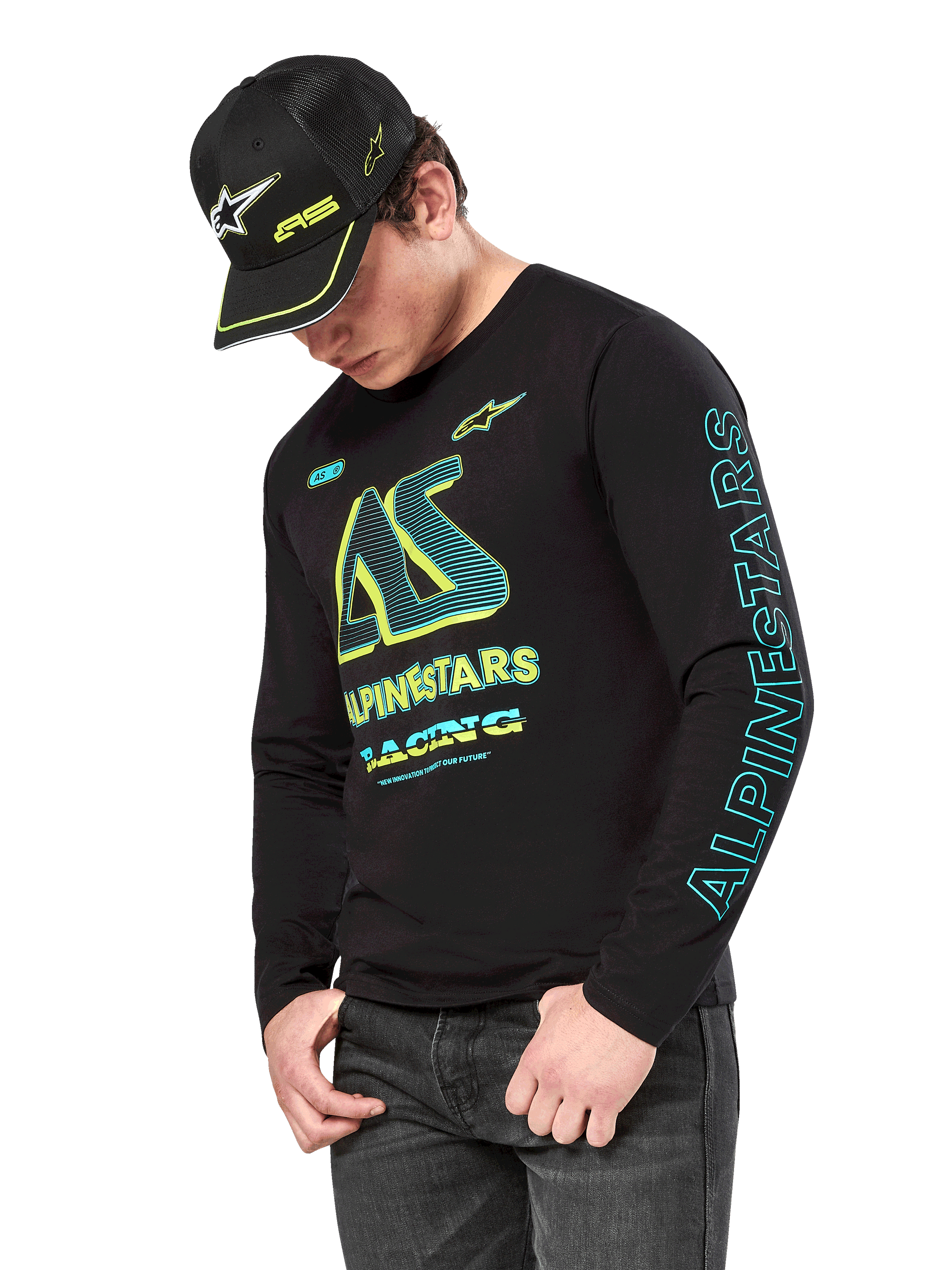 Alpinestars Ayess CSF Long Sleeve Tee, Black long sleeve shirt with neon yellow and cyan graphics, large AS chest logo and vertical Alpinestars branding on the sleeve, worn by a model with a matching black cap and dark jeans, casual motorsport lifestyle apparel