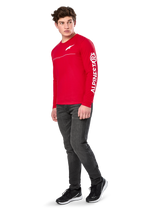 Alpinestars Committed CSF Tee, Long Sleeve T-Shirt, Red, featuring white Astars chest logo and Alpinestars sleeve branding, worn by a model with dark jeans and black sneakers, casual motorsport streetwear