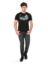Alpinestars Semicircle CSF Tee, Short Sleeve T-Shirt, Black, White and light blue curved graphic on chest, worn by model with dark grey jeans and black sneakers, casual motorsport streetwear