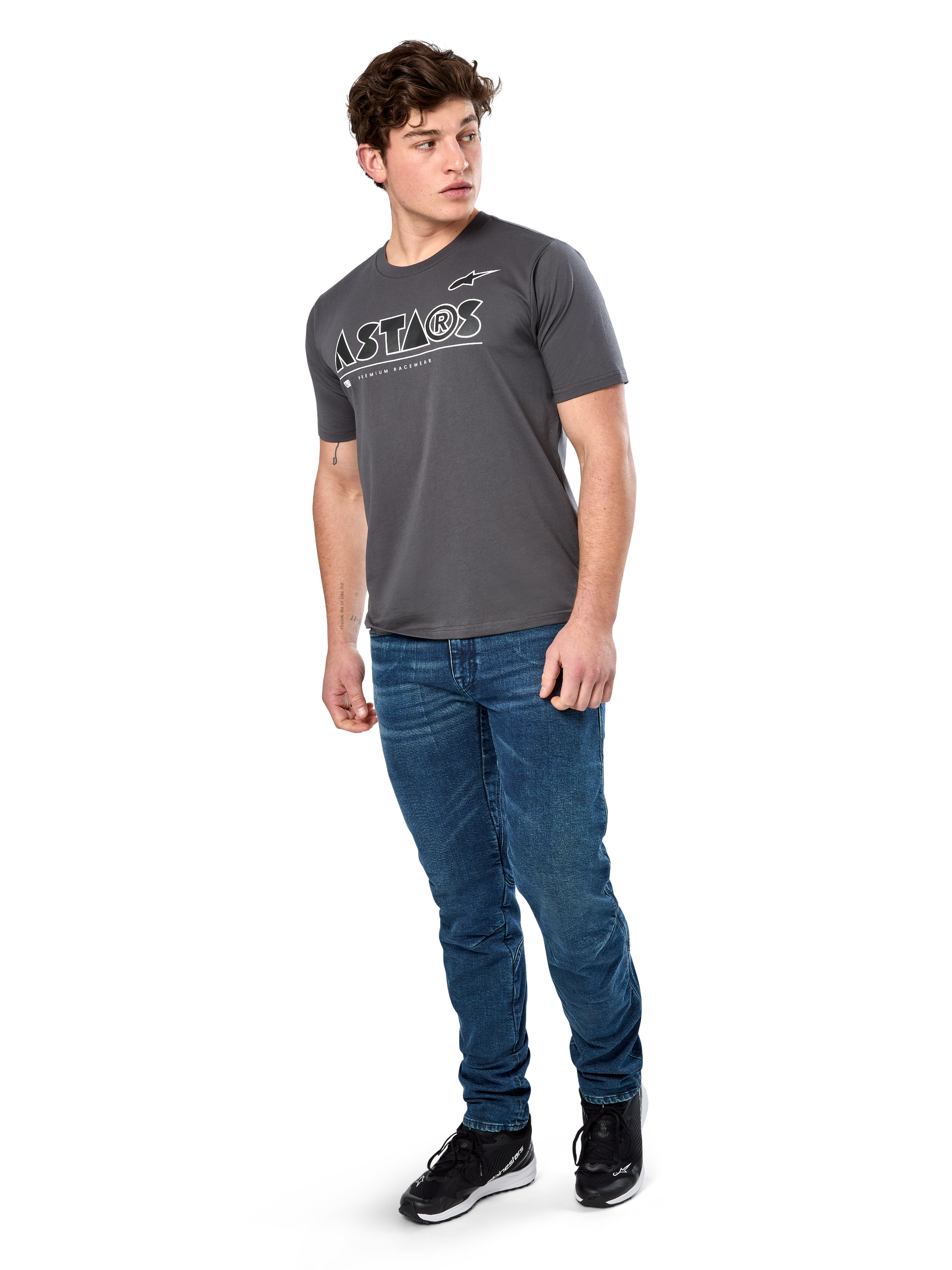 Alpinestars Cereal CSF Tee, Short Sleeve T-Shirt, Charcoal, White Geometric Astars Text Logo, Casual Motorsport Streetwear worn with blue jeans and black sneakers