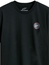 Alpinestars Dot Carbon CSF Tee, Short Sleeve T-Shirt, Black, Close-up of Circular Chest Logo with Carbon Fiber Look and White Astars Symbol, Casual Motorsport Streetwear