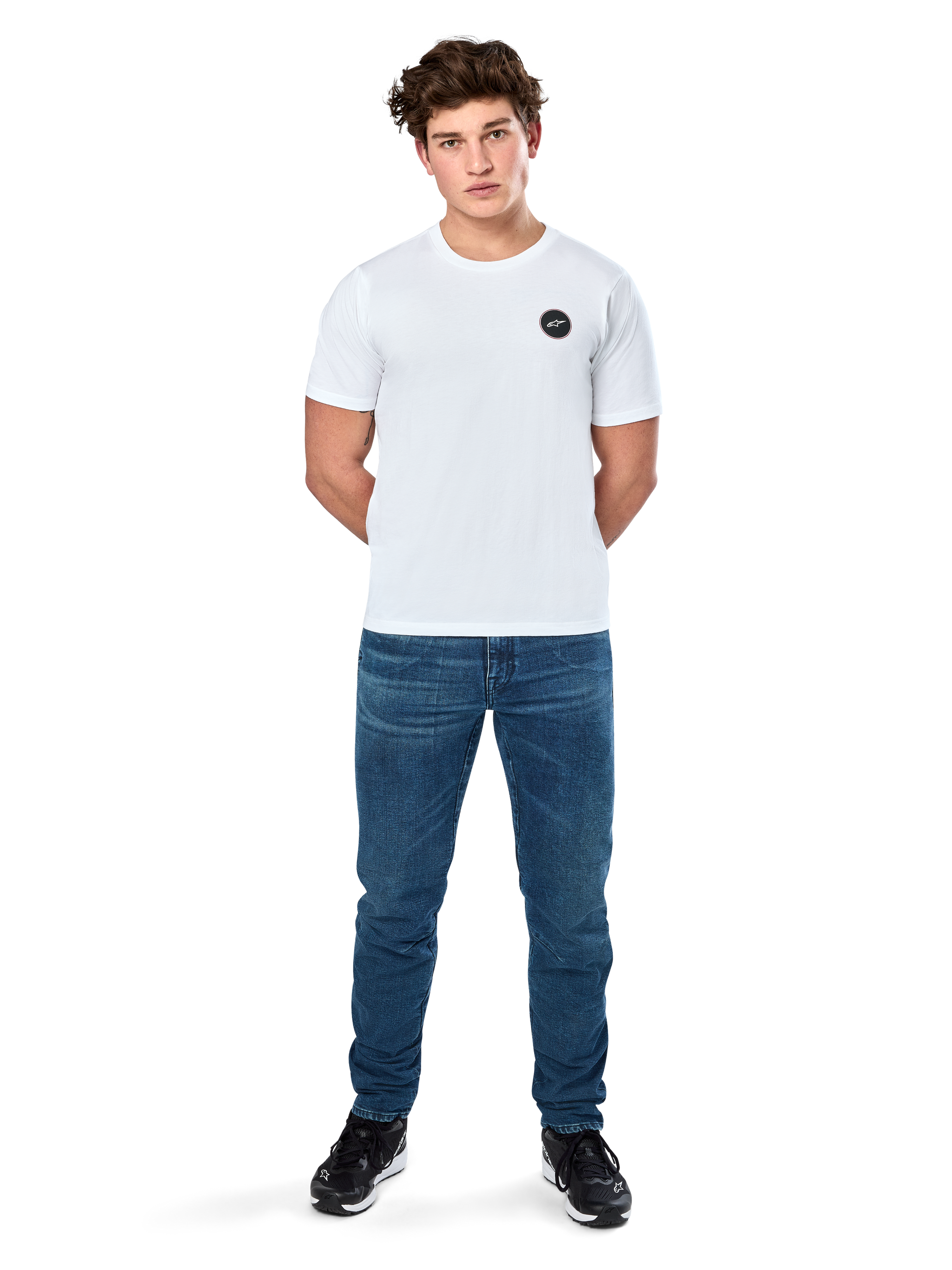 Alpinestars Dot Carbon Csf Tee, Short Sleeve T-Shirt, White, Circular Astars Logo with carbon fiber look, Casual Motorsport Streetwear, worn by a male model with blue jeans and black sneakers