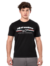 Alpinestars Prevail CSF Tee, Black Short Sleeve T-Shirt worn by a model, featuring white branding with a tri-color stripe and "PREMIUM RACEWEAR" graphic, casual motorsport streetwear