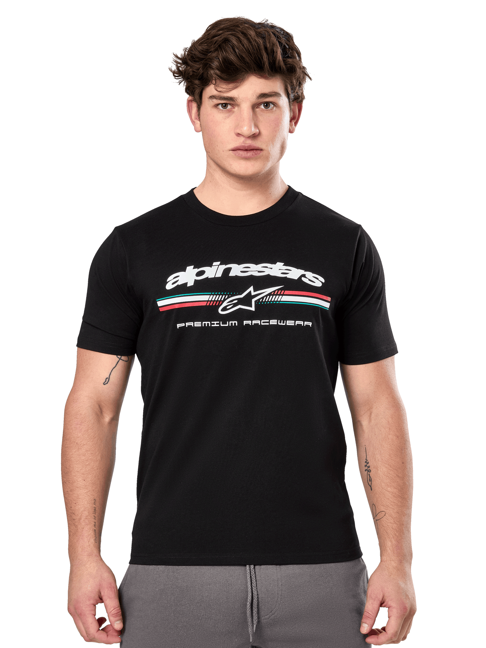 Alpinestars Prevail CSF Tee, Black Short Sleeve T-Shirt worn by a model, featuring white branding with a tri-color stripe and "PREMIUM RACEWEAR" graphic, casual motorsport streetwear