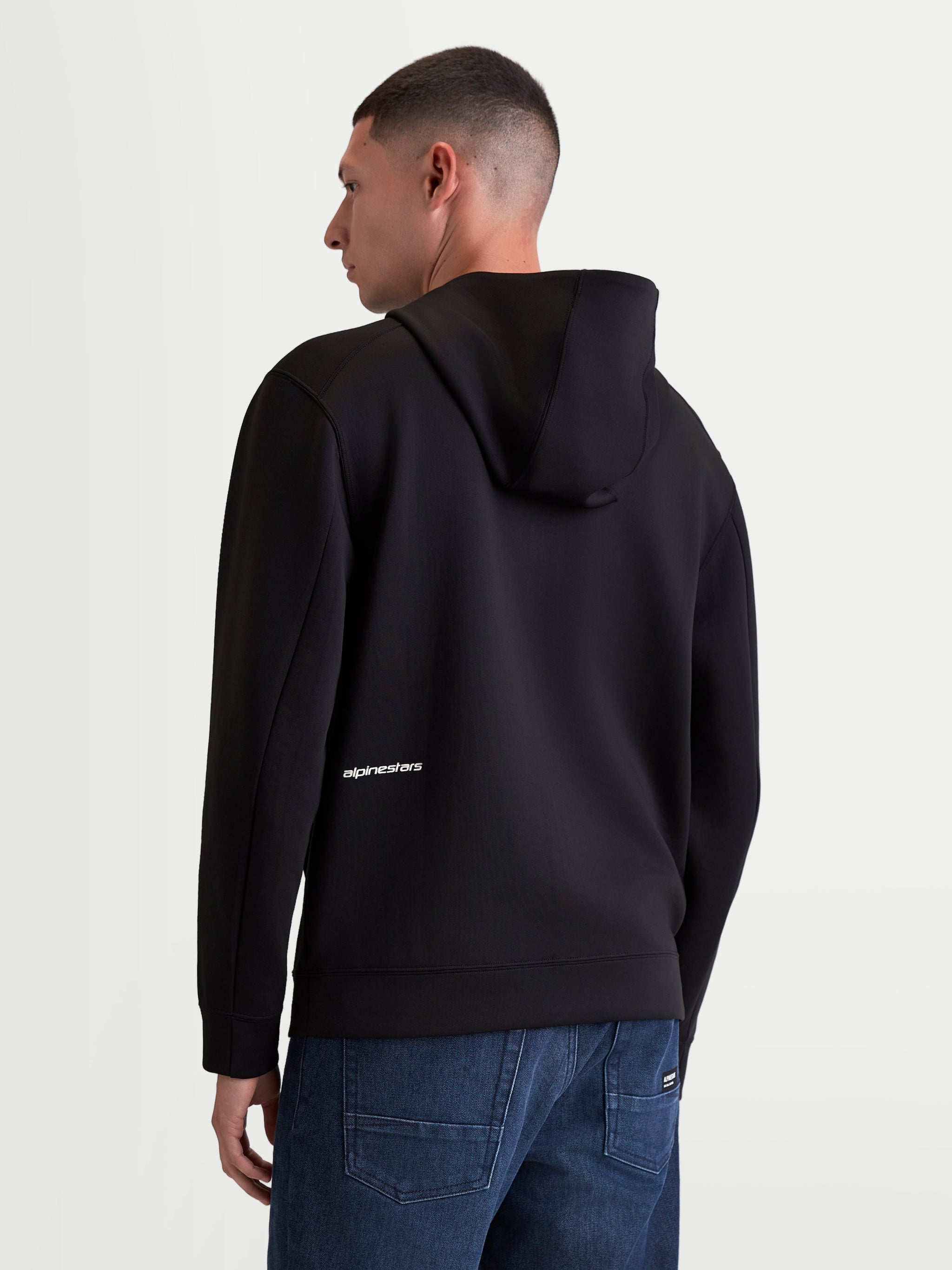 Alpinestars Cypher Hoodie, Men's Sportswear Zip-up Hoodie, Black Tri-blend Double Face Fleece, back view on model featuring a high neck hood and white Alpinestars word logo on the lower back.