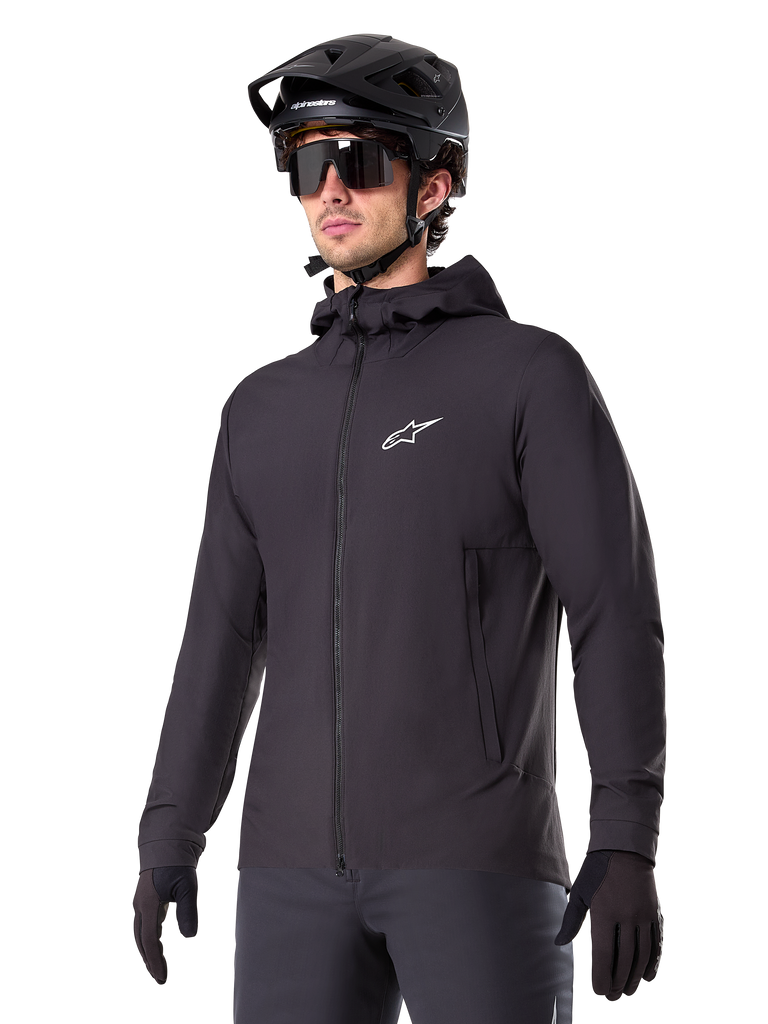 Alpinestars A-Dura Thermal Jacket, Black Cycling Jacket, hooded design with front zipper, white star logo on chest, worn with black mountain bike helmet and gloves, sporty performance gear for cold weather trail riding