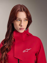 Alpinestars Stella A-Dura Elite Waterproof Jacket, Red Fluo, worn by a woman with long red hair, technical 3-layer waterproof jacket with high collar and white logo, performance outdoor and mountain bike gear