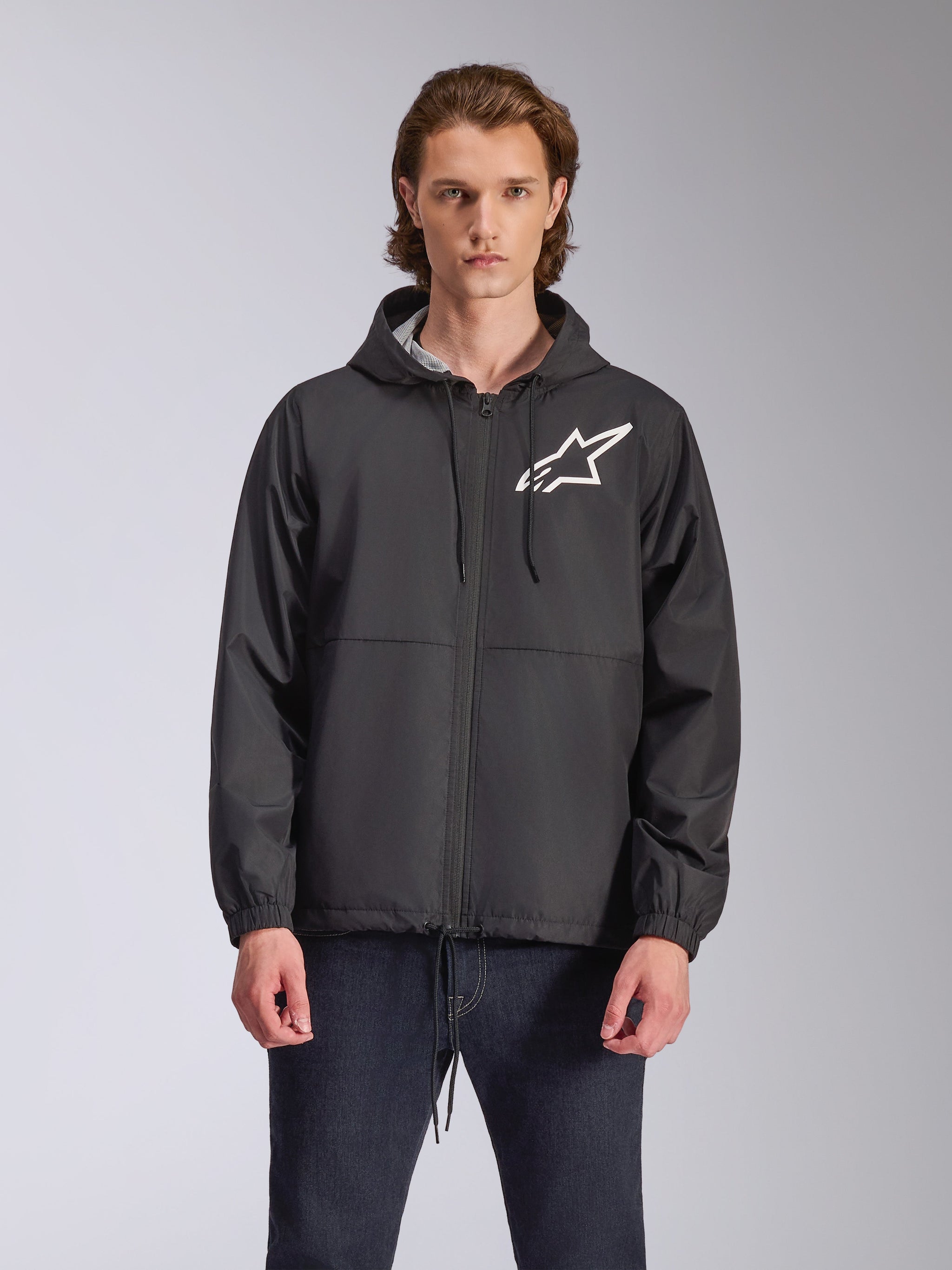 Alpinestars Speeder Chromium Windbreak Jacket, Black hooded jacket with a white star logo on the chest, featuring a front zipper, drawstring hood, and elastic cuffs, motorsport-inspired casual streetwear