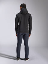 Alpinestars Blaze V3 Hoodie, casual streetwear, black, back view of hooded fleece sweatshirt, worn with dark blue denim jeans and black shoes, clean motorsport-inspired design