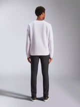 Alpinestars Bettern Crew, white crewneck sweatshirt, back view on model, paired with dark jeans and sneakers, casual motorsport-inspired streetwear