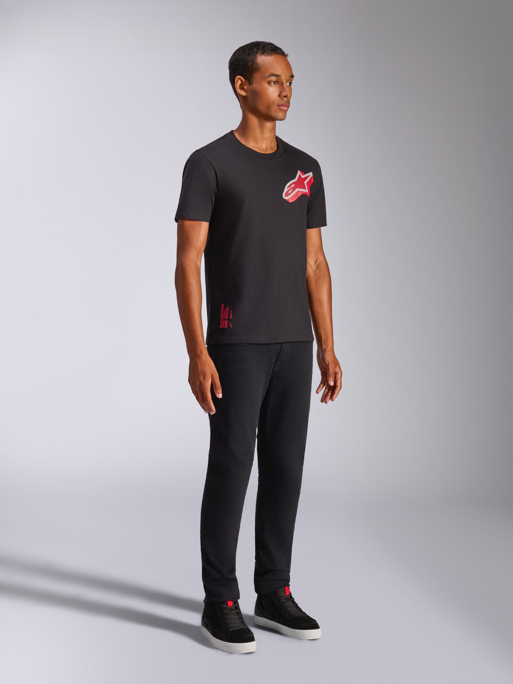 Alpinestars Shaded CSF Tee, Short Sleeve T-Shirt, Black, Red and White Slanted Gradient Foil Astars Logo, Casual Motorsport Streetwear, full-length shot of a model wearing black pants and sneakers