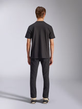 Alpinestars Fasting CSF Tee, Short Sleeve T-Shirt, Black, rear view on model, worn with black pants and sneakers, casual motorsport-inspired streetwear