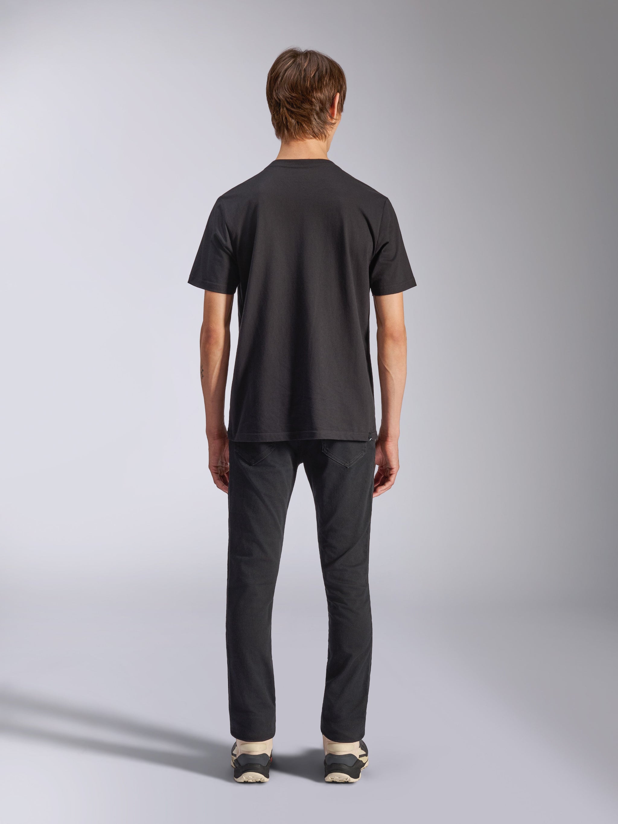 Alpinestars Fasting CSF Tee, Short Sleeve T-Shirt, Black, rear view on model, worn with black pants and sneakers, casual motorsport-inspired streetwear