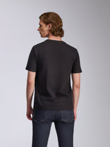 Alpinestars Global CSF Tee, Short Sleeve T-Shirt, Black, back view worn by a model, paired with dark blue jeans, casual motorsport streetwear