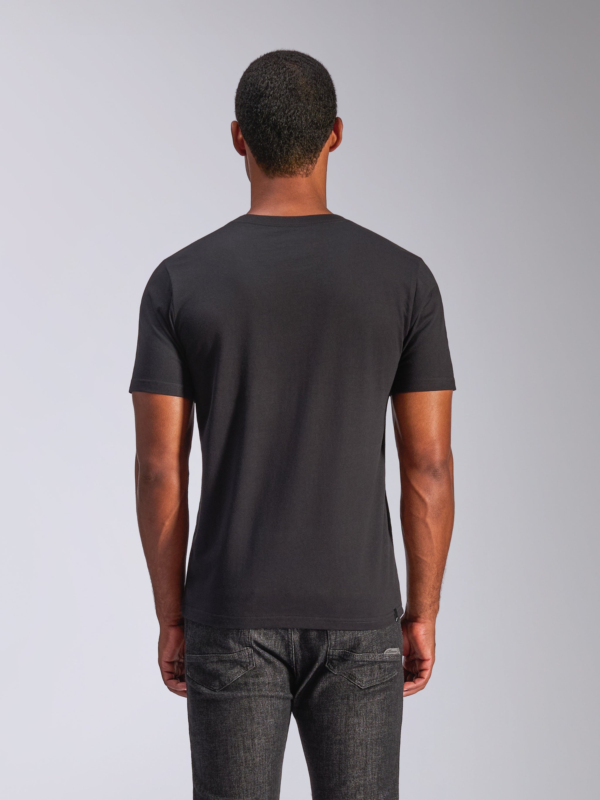 Alpinestars Heritage Patch CSF Tee, Short Sleeve T-Shirt, Black, back view, worn by a man with dark jeans, casual motorsport streetwear