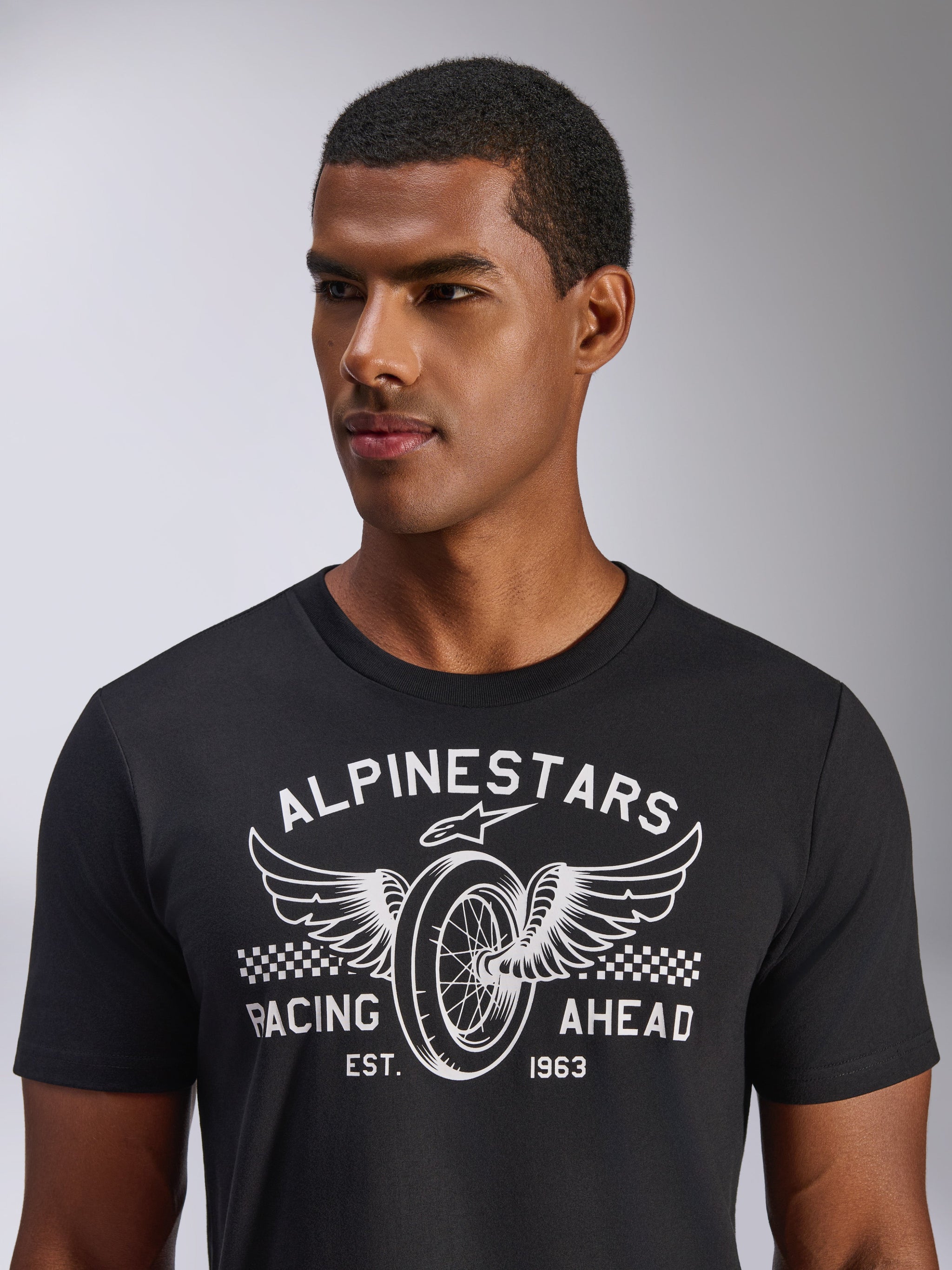 Alpinestars Heritage Patch CSF Tee, Short Sleeve T-Shirt, Black, White front graphic featuring a winged wheel and Racing Ahead text, Casual motorsport streetwear