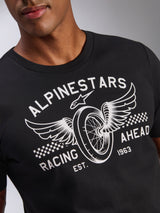 Alpinestars Heritage Patch CSF Tee, Short Sleeve T-Shirt, Black, featuring a detailed white chest graphic with a winged motorcycle wheel, 'ALPINESTARS' branding, 'RACING AHEAD', and checkered accents, casual motorsport streetwear