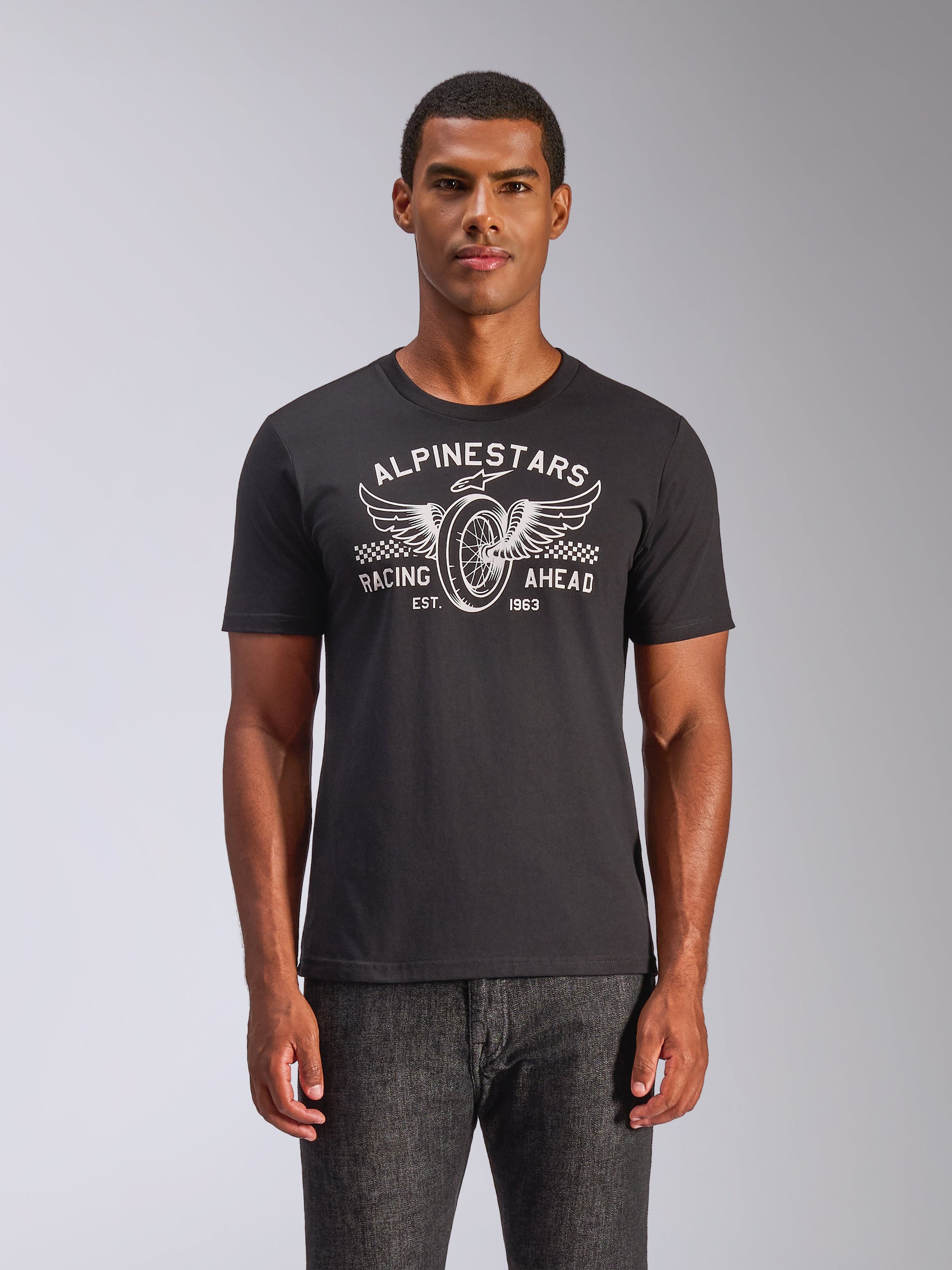 Alpinestars Heritage Patch CSF Tee, Short Sleeve T-Shirt, Black, white winged wheel graphic with 'Racing Ahead' text and checkered accents, Casual Motorsport Sportswear