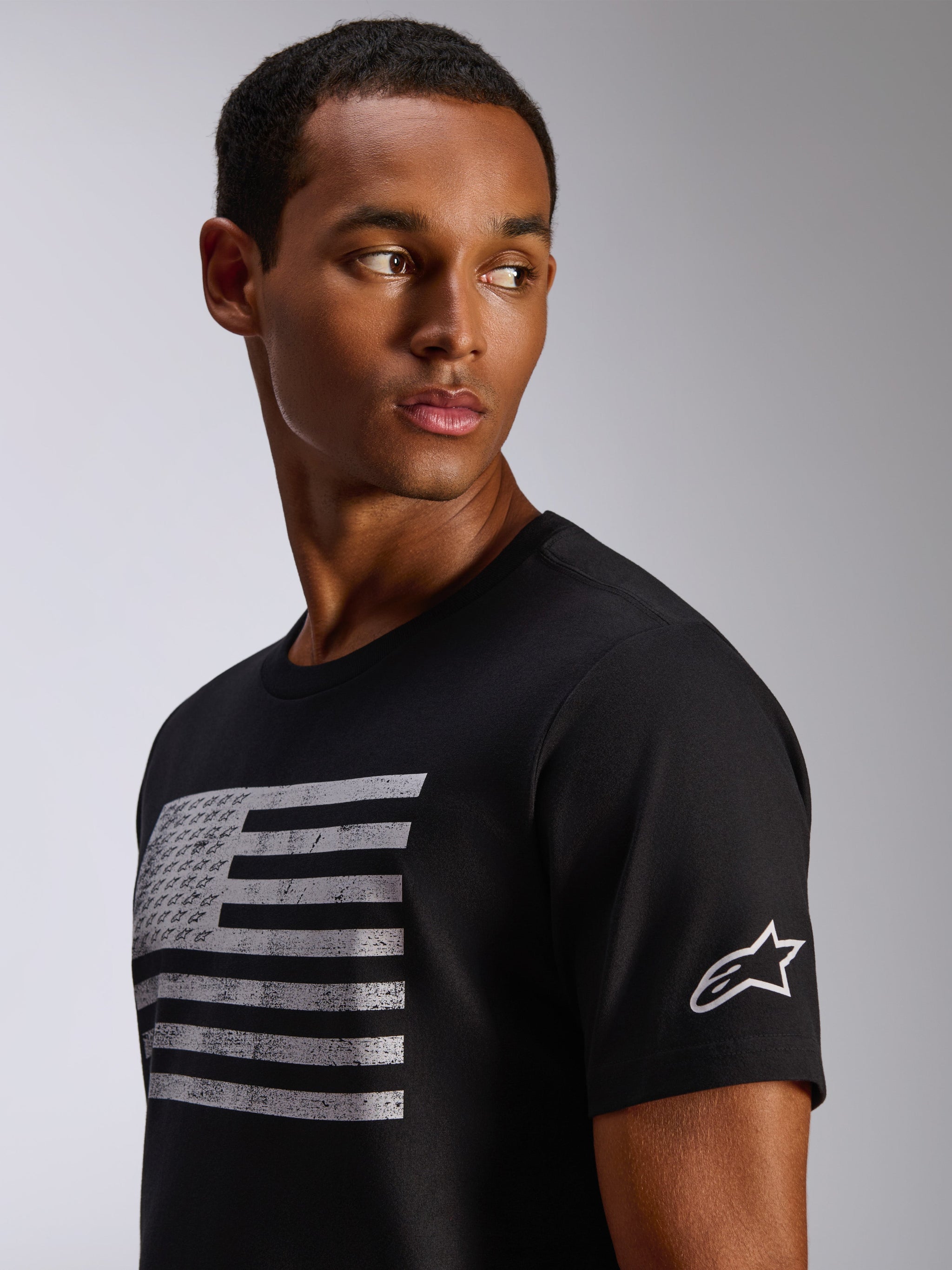Alpinestars Waving CSF Tee, Short Sleeve T-Shirt, Black, distressed flag graphic with integrated logos on chest, white Astar logo on sleeve, casual motorsport streetwear