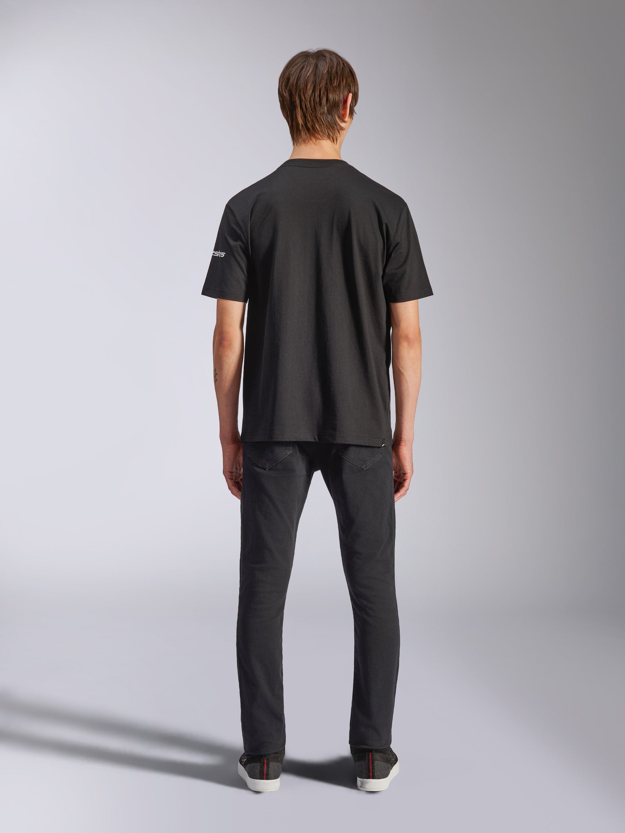 Alpinestars Frontal CSF Tee, Short Sleeve T-Shirt, Black, Rear view on model wearing black jeans, casual performance streetwear featuring small white sleeve logo detail