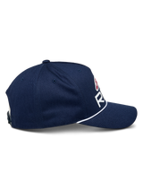 Alpinestars Ride Comp Snapback Hat, Navy Blue with White and Red accents, side profile view showing curved bill and white braided rope trim, structured crown, casual motorsport headwear