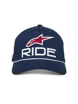 Alpinestars Ride Comp Snapback Hat, Navy Blue with White and Red accents, featuring a 3D RIDE logo, red star emblem, and white braided rope trim, curved bill, casual motorsport headwear