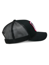 Alpinestars Booted Trucker Hat, black mesh-back snapback cap, side view highlighting the breathable poly mesh, braided rope trim, and curved bill, casual motorsport headwear