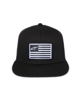 Alpinestars Flag Flat Trucker Hat, Black, flat-brim cap with structured crown, central rectangular patch with white flag and Alpinestars logo, mesh back, casual motorsport-inspired streetwear