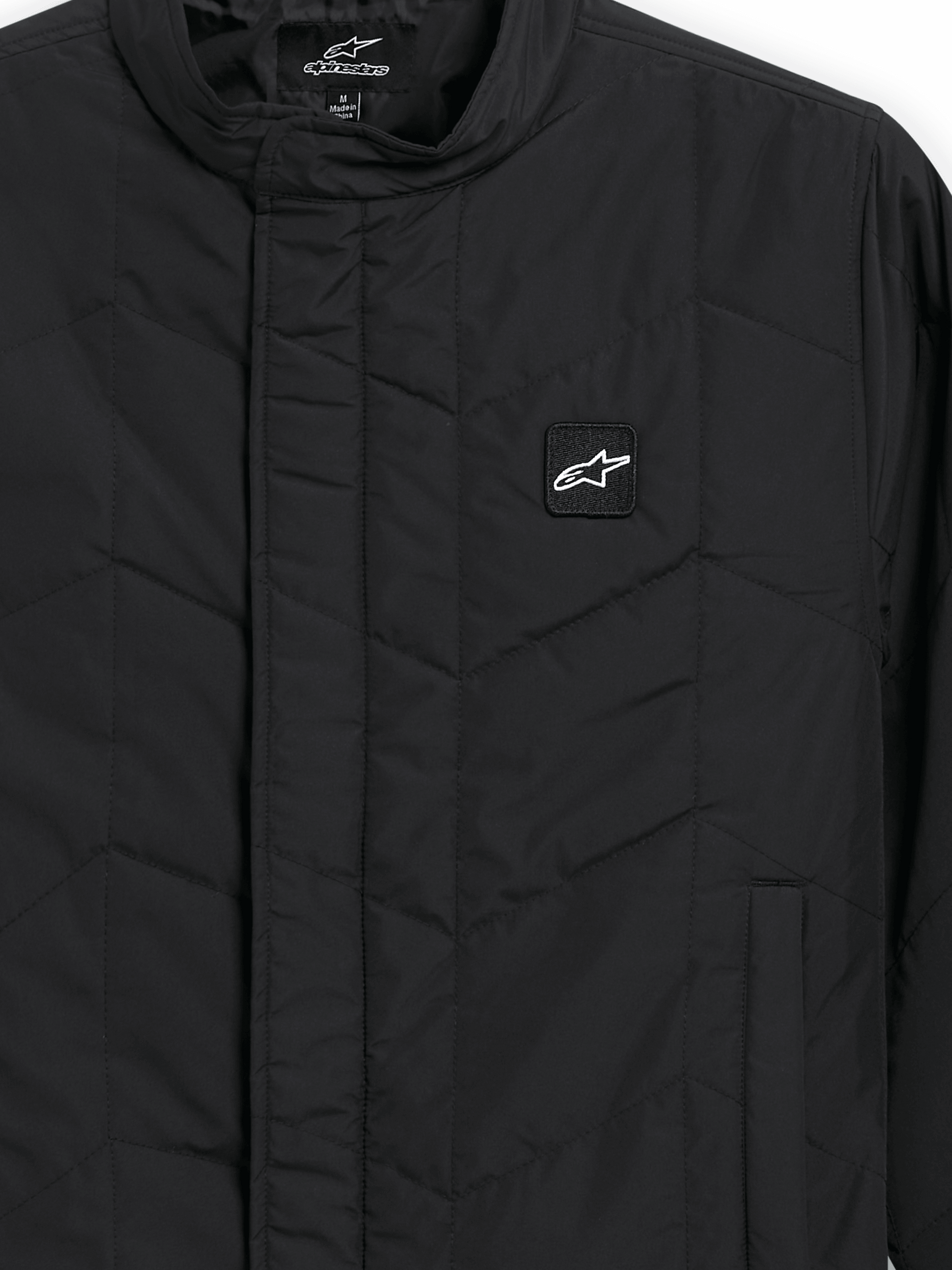 Alpinestars Precedent Jacket, Quilted Sportswear Jacket, Black, close-up view featuring an iconic angled quilt pattern, low track collar, covered front zipper, and small chest logo patch