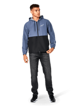 Alpinestars Speeder Windbreaker Jacket, Slate Blue and Black, hooded lightweight jacket with mesh lining, white star logo on chest, worn with black jeans and sneakers, casual motorsport streetwear design.