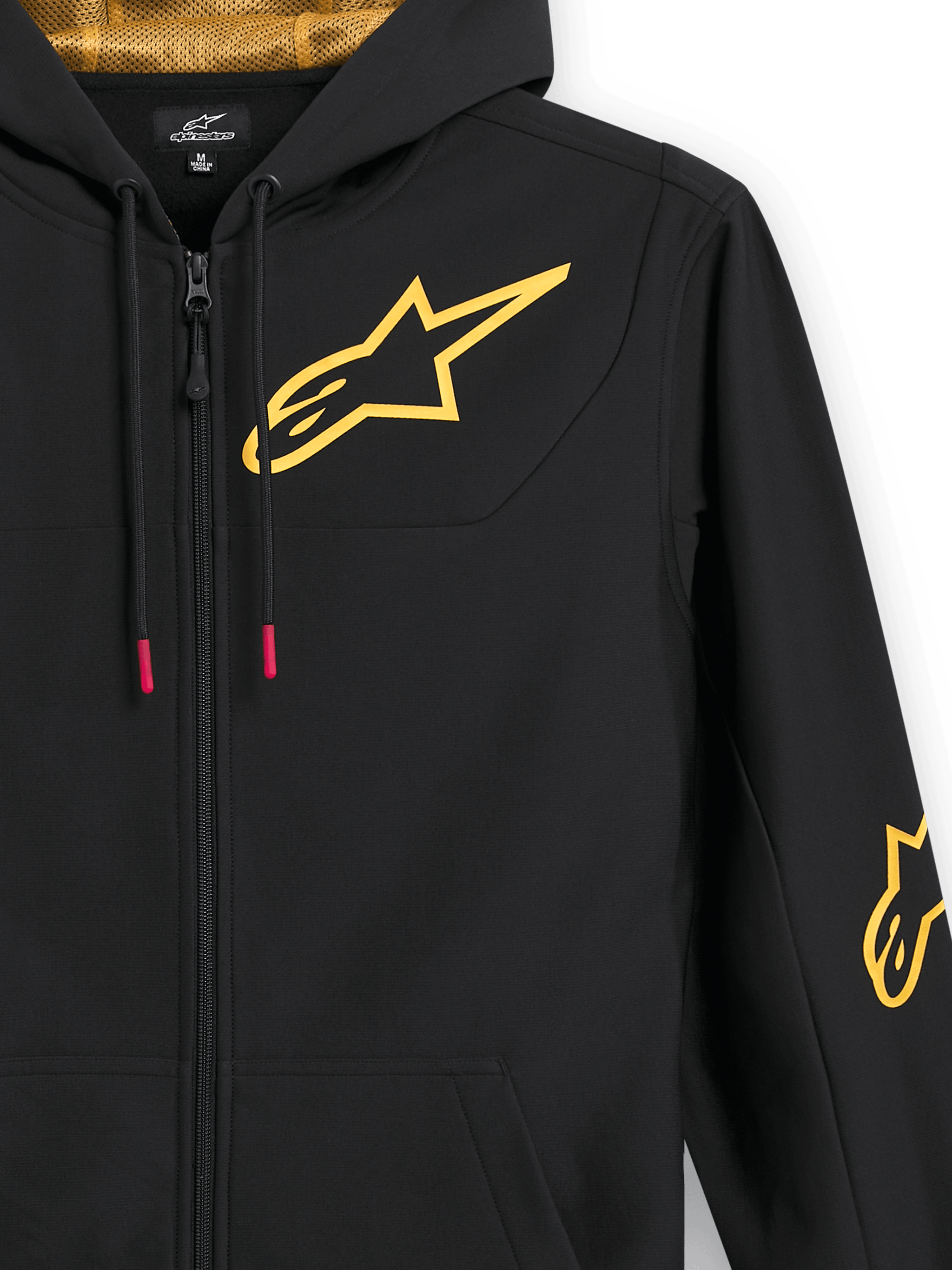 Alpinestars Sessions V3 Hoodie, black zip-up fleece, close-up showing large gold chest logo, gold mesh-lined hood, tech drawcords with red accents, casual motorsport-inspired streetwear