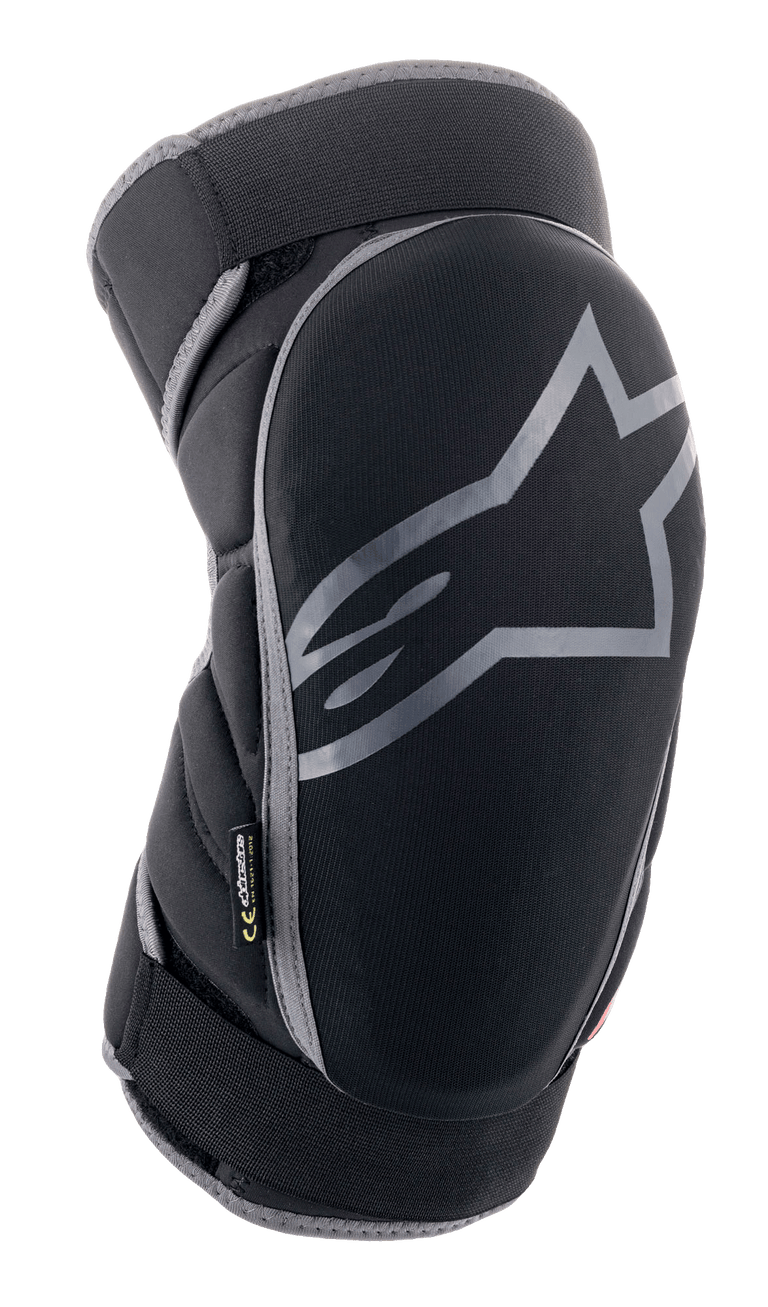 Alpinestars Vector Knee Protectors, MTB protection gear, black and anthracite gray, featuring a large gray star logo, segmented side padding, and adjustable straps for off-road cycling