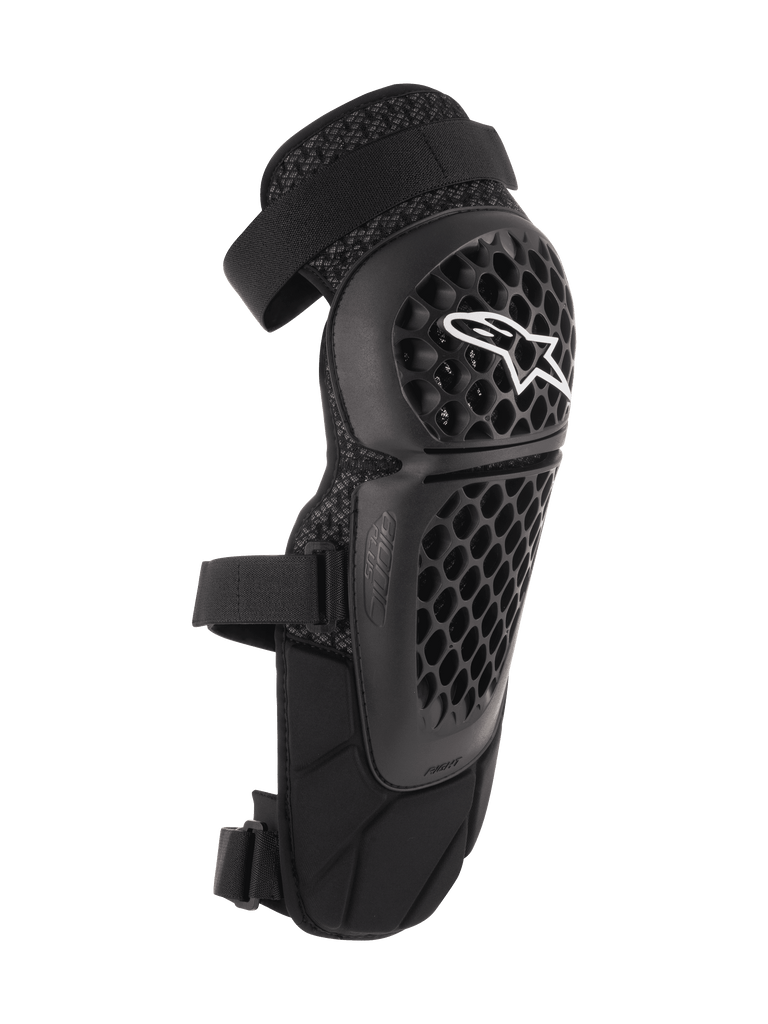 Alpinestars Bionic Plus Knee/Shin Protectors, Black, Off-road and MTB Protection, featuring a perforated honeycomb shell with a white Alpinestars logo, dual adjustable straps, and 3D mesh ventilation, ergonomic curved design