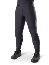 Alpinestars A-Dura Thermal Pant, Black Mountain Bike Pants, worn with black cycling shoes, featuring a ratchet waist closure, small white logo on the thigh, tapered fit for cold-weather riding