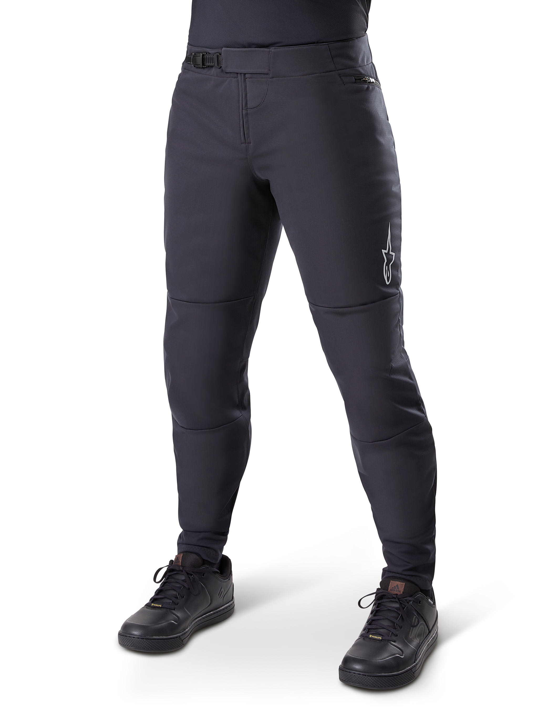 Alpinestars A-Dura Thermal Pant, Black Mountain Bike Pants, worn with black cycling shoes, featuring a ratchet waist closure, small white logo on the thigh, tapered fit for cold-weather riding
