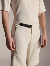 Alpinestars A-Aria Elite Shorts, Mountain Bike Shorts, Ecru, close-up view showing the black magnetic buckle closure, side zippered pocket, and laser-cut ventilation, technical performance cycling apparel