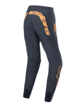Alpinestars A-Supra Race Pants, MTB Cycling Pants, Black with orange graphics, rear view featuring large Alpinestars wordmark on the back yoke, zippered side pocket, and tapered performance fit with mesh ankle panels