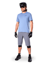 Alpinestars A-Dura Shorts, MTB Shorts, Dark Gray, worn by a rider with a light blue jersey, black MTB helmet, black gloves, and knee guards, complete mountain bike outfit for trail and off-road riding