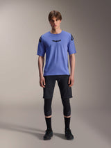 Alpinestars A-Aria Elite Shorts, MTB Mountain Biking Shorts, Black Titanium, worn with blue short-sleeve jersey, knee guards, and black biking shoes, full-body studio shot, performance mountain bike apparel