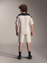 Alpinestars A-Aria Elite Shorts and A-Aria Polartec Elite SS Jersey, Ecru with black shoulder panels, rear view of a model in mountain bike performance gear, styled with black socks and shoes