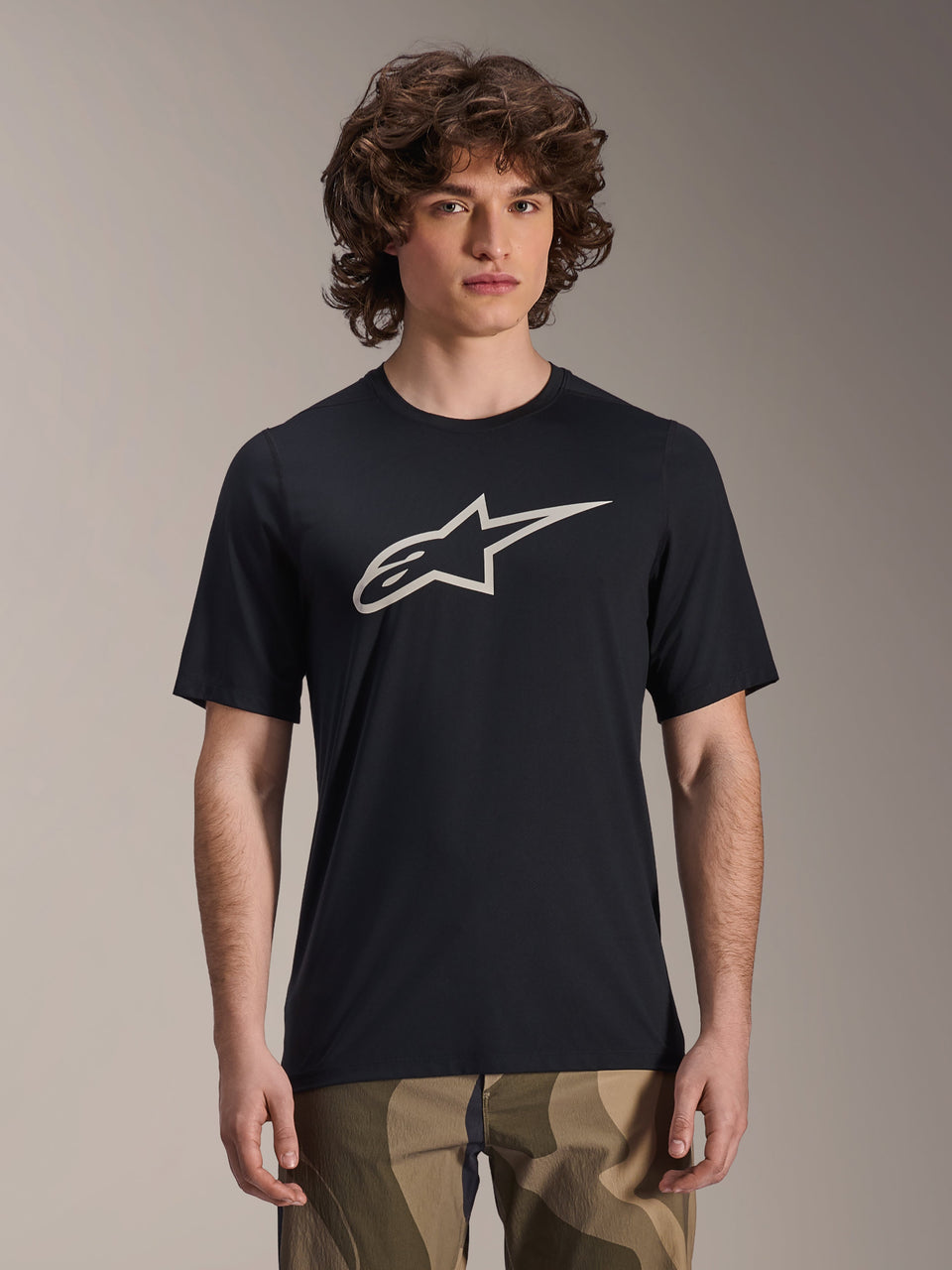Alpinestars A-Dura Astar Jersey, Short Sleeve MTB Jersey, Black with white star logo, worn with camouflage pants, casual mountain biking apparel, technical moisture-wicking fabric