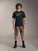Alpinestars A-Dura Astar Short Sleeve Jersey, Black with large white Astars logo on the chest, worn by a model with camouflage MTB shorts and black cycling shoes, casual mountain bike apparel.