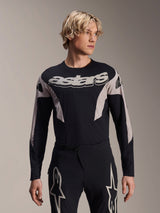 Alpinestars A-Supra Melt Jersey Long Sleeve, MTB Mountain Bike Jersey, Black and Gray, featuring 'astars' graphic across the chest and patterned sleeves, worn with matching performance pants